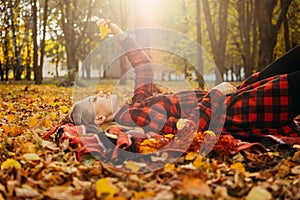 Life Style Portrait of Happy Woman in fall park. Beautiful girl on the nature picnic camping. Relaxing Girl in autumn Nature.