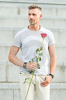 Life is too short to live without love. Handsome guy with rose flower romantic date. Man in love romantic mood. Surprise