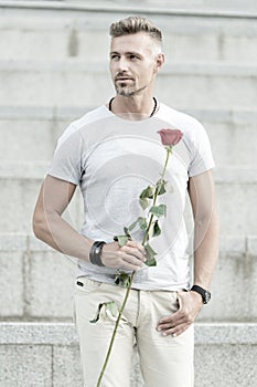 Life is too short to live without love. Handsome guy with rose flower romantic date. Man in love romantic mood. Surprise