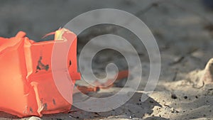 Life vest on abandoned beach, death after plane crash or shipwreck, catastrophe