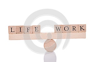 Life and work blocks balancing on seesaw photo