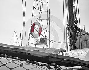 A lifebelt, lifebuoy, water wheely also known as Kisbee ring hanging from the sailing ropes of the mast