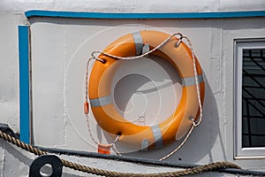 Lifebelt with lifeline on a white background on a ship