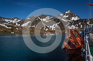 Lifeboat on board a ship in the harbor in front of Grytviken Whaling Station on South Georgia photo