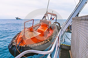 Lifeboat or FRC rescue boat in the vessel at sea. dsv ship is on background