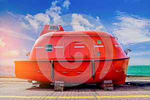 Lifeboat orange on the floor under repair