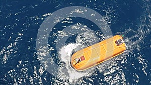 Lifeboat test drive on clam sea at offshore platform