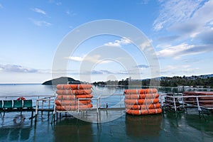 Lifeboats on board the ferry on a background of blue sky.