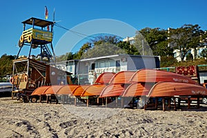 Lifeboats labeled Rescuer are overturned and stacked. Rescue tower and life buoys at the rescue station in Odessa Ukraine