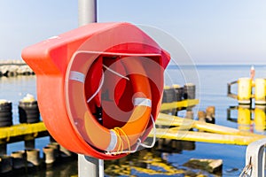 A lifebuoy attached to the breakwater at the harbor entrance