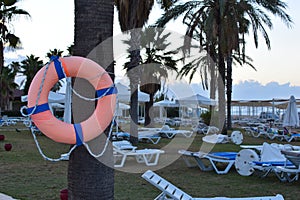 Lifebuoy on beach near hotel pool. safety equipment on the water in  hotel by the sea