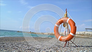 Lifebuoy on the beach. Orange lifebuoy in the beach