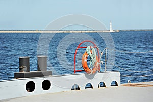 Lifebuoy and bollard on pier