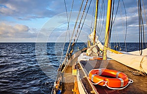 Lifebuoy on the deck of an old sailing schooner at sunset