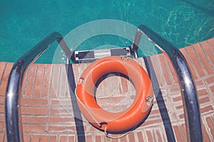 Lifebuoy at the edge of swimming pool