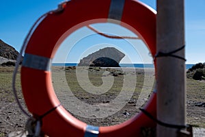 Lifebuoy Framing Rock Formation at Cabo de Gata, Spain photo