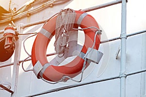 Lifebuoy on handrails of frigate or warship. Rope wound on handrails with lifesaver