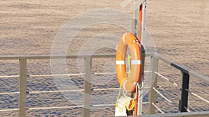 Lifebuoy hang on the pier in the sea. Marina bay equipment.