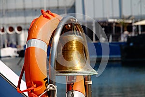 A lifebuoy with inside the signal bell of a motorboat