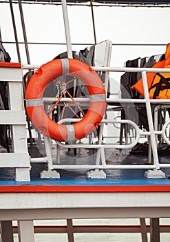 Lifebuoy and life jackets on a ferry deck close-up. Rescue equipment