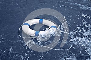 Lifebuoy, lifebelt, lifesaver in ocean storm as help, hope concept