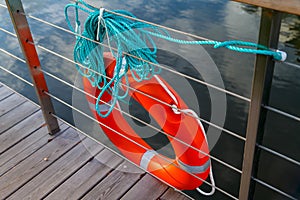 Lifebuoy orange color on the fencing of the lake shore. lifebuoy to rescue those who fell into the water