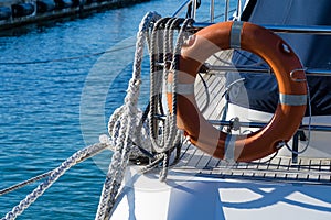 Lifebuoy or orange life ring on white ship with Black sea backdrop. Safety equipment. Obligatory ship equipment,