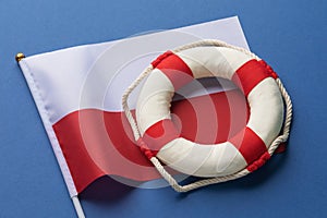 Lifebuoy and Poland flag on a colored background, concept on the theme of help