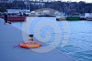 Lifebuoy ring on berth near the bollard with sea view of Marina outdoors