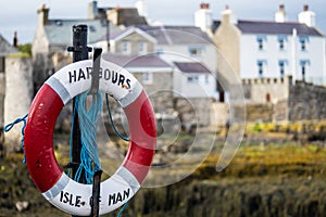 A lifebuoy, ring buoy, lifering, lifesaver, life donut, life preserver or lifebelt is a life saving buoy. Castletown Harbour, Isle
