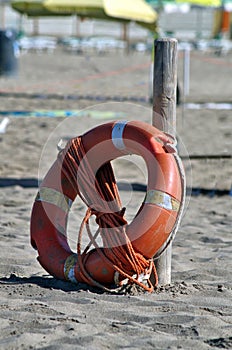 Lifebuoy and rope on the beach