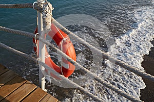 Lifebuoy with a rope is a means of saving a man drowning in the sea