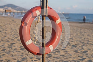 Lifebuoy on a sandy beach somewhere in Turkey against the backdrop of the beach, mountains and sea.