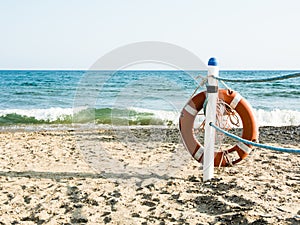 Lifebuoy on a sandy sea beach in Terracina, Italy. Safe swimming