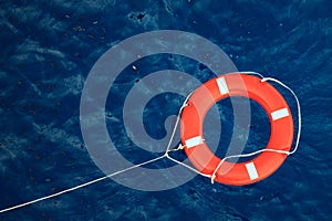 Lifebuoy in a stormy blue sea, safety equipment in boat.