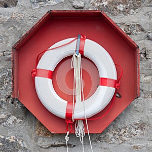 Lifebuoy on wall, red, white