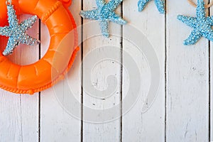 Lifebuoy on white wooden background. Sea style composition.