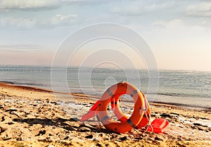 Lifebuoys and accessories on the sand