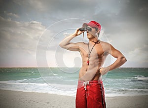 Lifeguard with binoculars