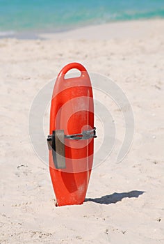 Lifeguard buoyancy aid sticking in the sand