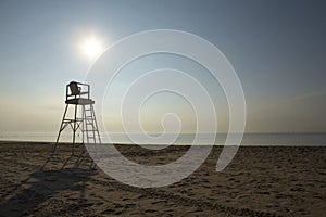 Lifeguard chair on vacant sand beach