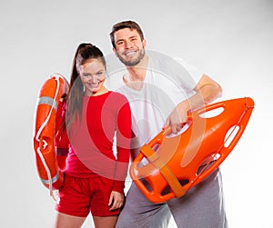 Lifeguard couple with rescue equipment
