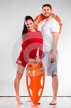 Lifeguard couple with rescue equipment