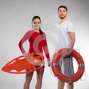 Lifeguard couple with rescue equipment