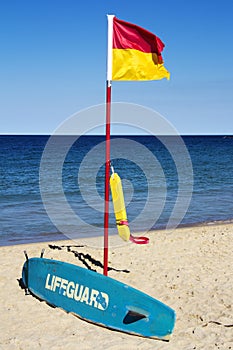 Lifeguard flag, surfboard and flotation device