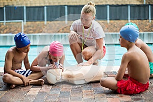 Lifeguard helping children during rescue training