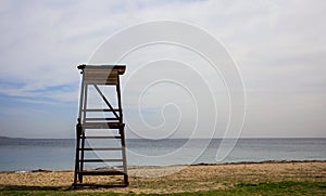 Lifeguard hut on an empty sandy beach. Blue sky and calm sea background.