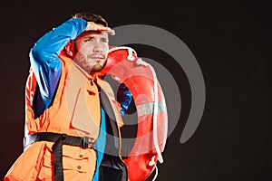 Lifeguard in life vest with ring buoy lifebuoy.