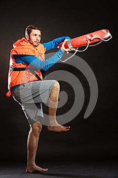 Lifeguard in life vest with ring buoy lifebuoy.