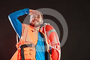 Lifeguard in life vest with ring buoy lifebuoy.